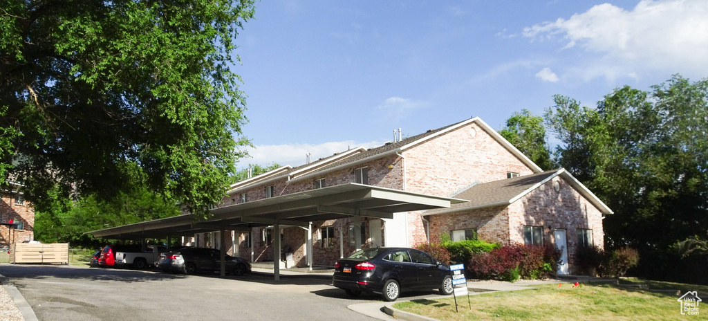 View of parking featuring a carport