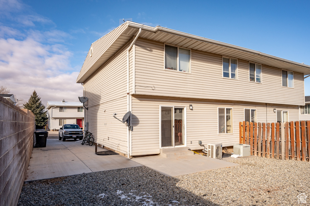 Rear view of property featuring a patio and central AC unit