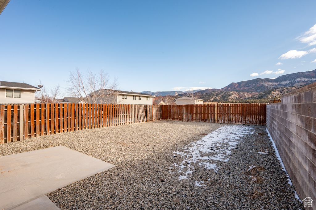 View of yard featuring a mountain view and a patio area