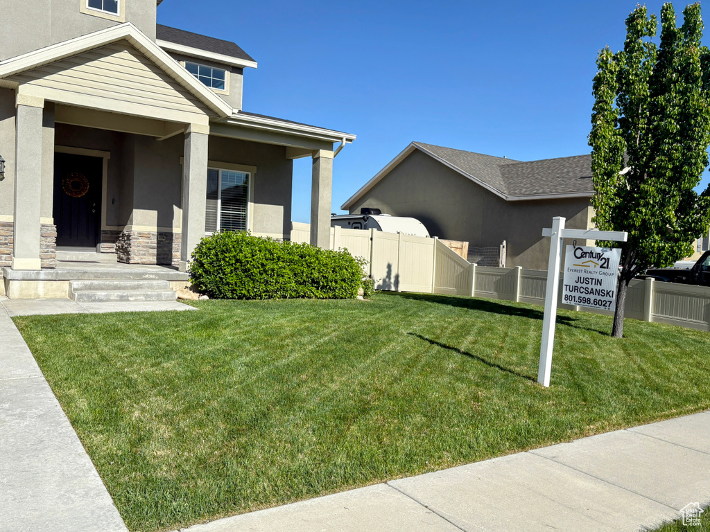 View of side of property featuring stucco siding and stone siding