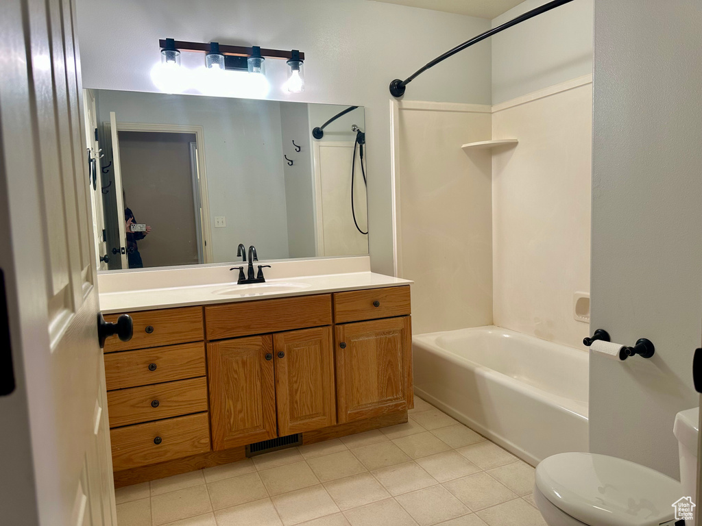 Full bathroom featuring vanity, tile patterned flooring, bathtub / shower combination, and toilet