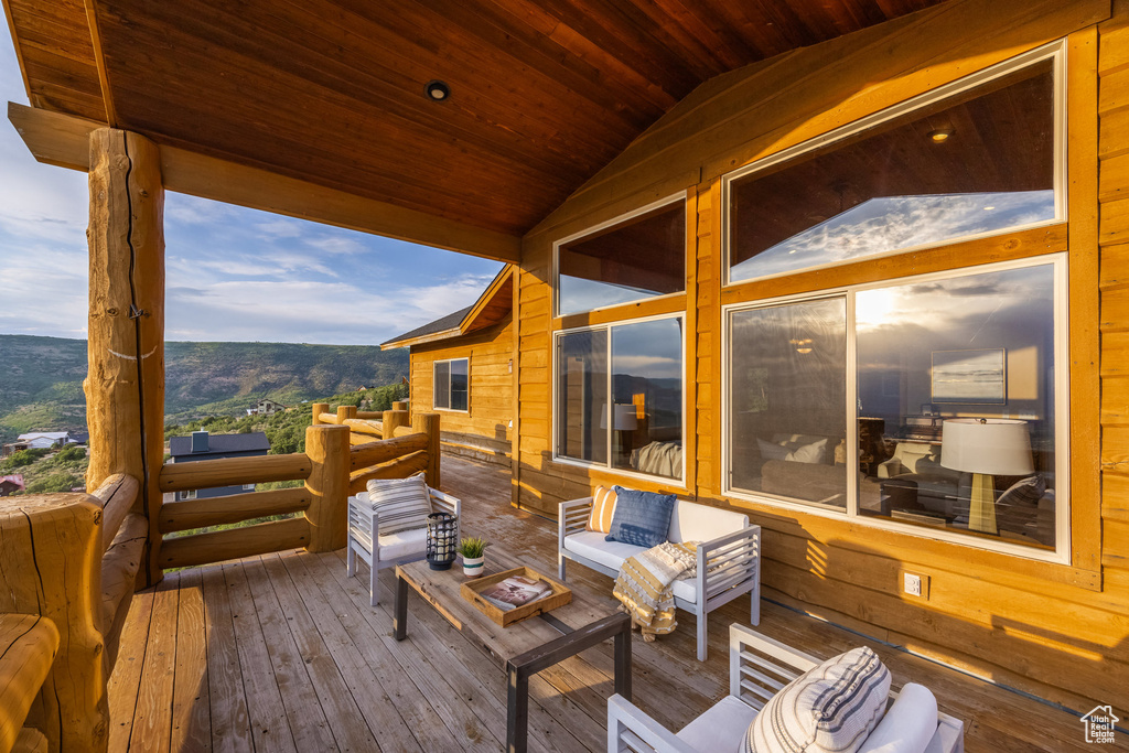 Wooden deck with a mountain view and an outdoor living space