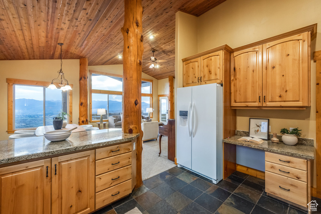 Kitchen featuring white fridge with ice dispenser, lofted ceiling, light brown cabinets, wood ceiling, and light stone countertops