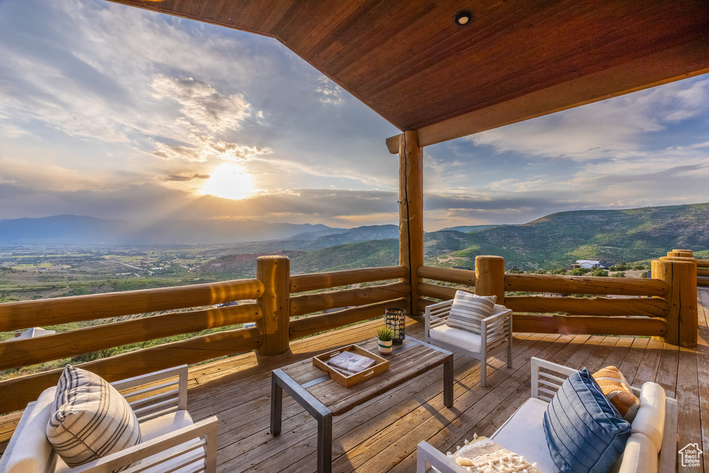 Deck at dusk featuring a mountain view