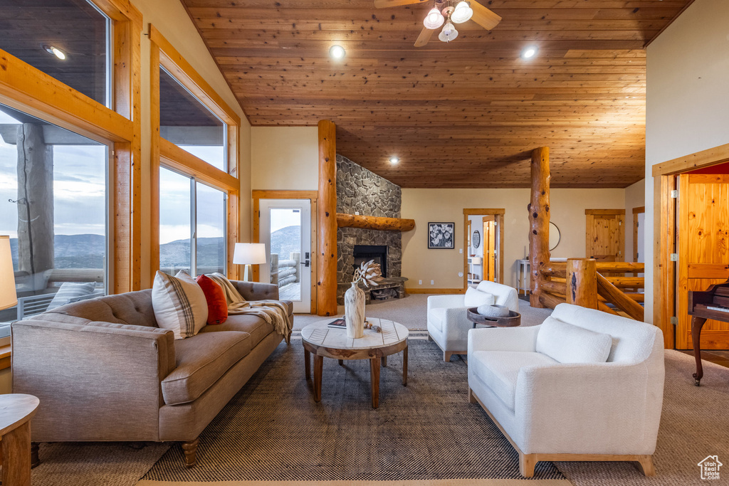 Carpeted living room with wood ceiling, ceiling fan, recessed lighting, a mountain view, and a fireplace