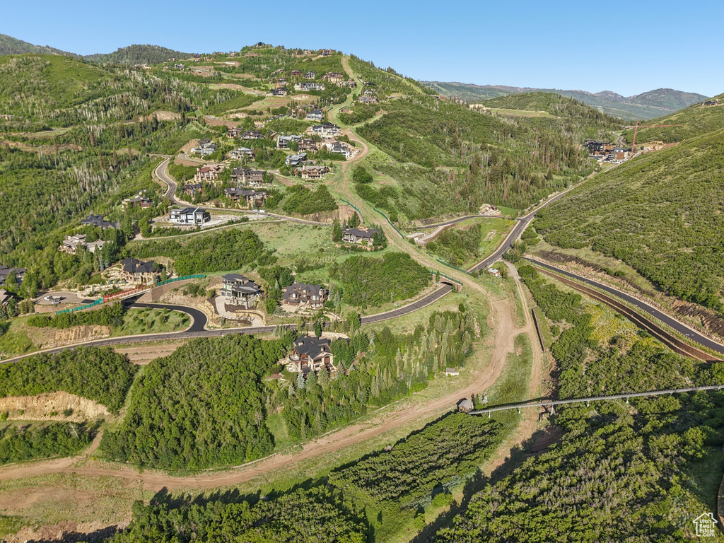 Aerial overview of property's location with a mountainous background