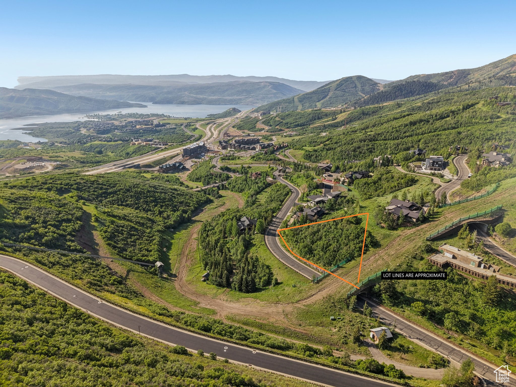 Aerial view of property's location with property parcel outlined and a water and mountain view