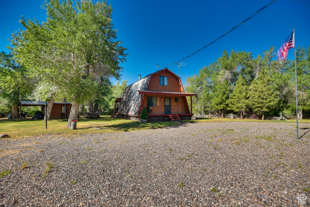 View of front facade featuring a front lawn and covered porch