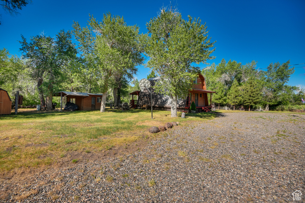 View of yard with a storage unit