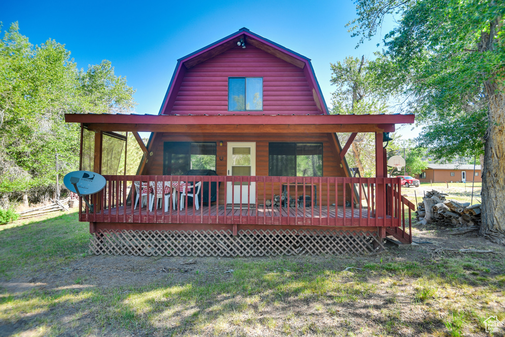 Back of property featuring a lawn