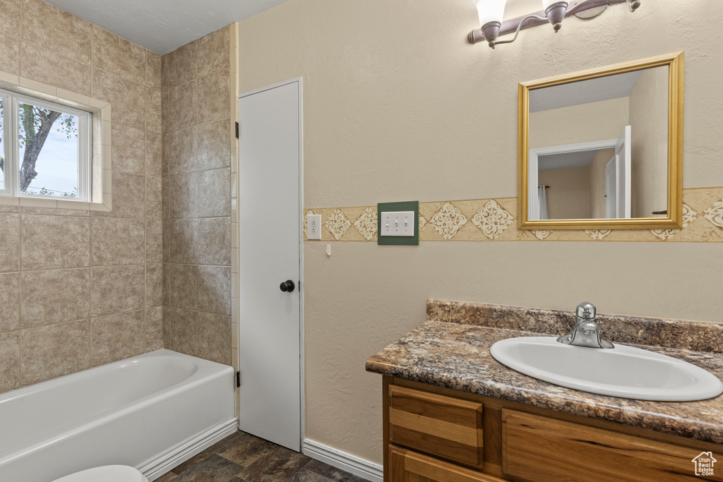 Bathroom featuring vanity and  shower combination