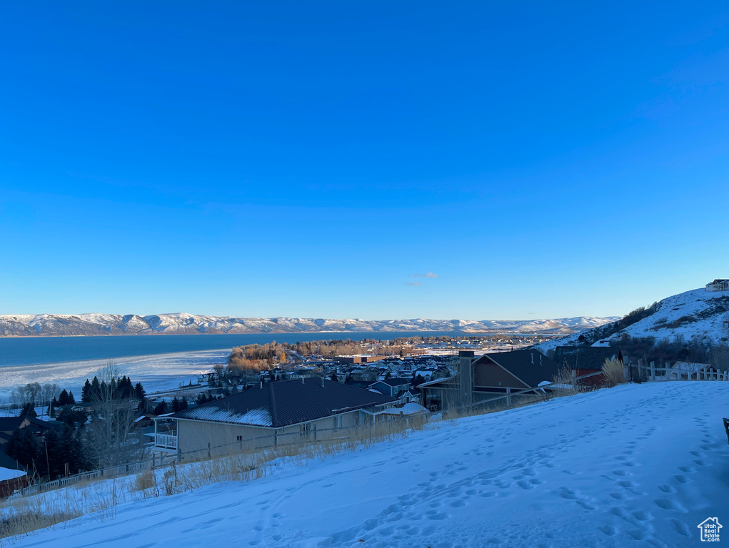 Snowy yard featuring a mountain view