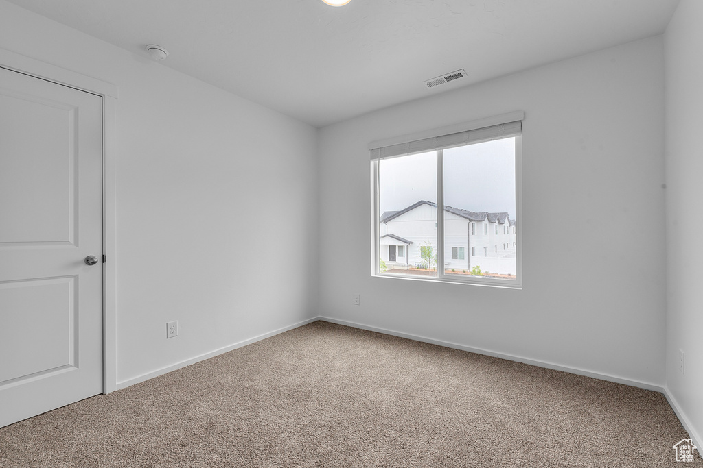 Spare room featuring carpet