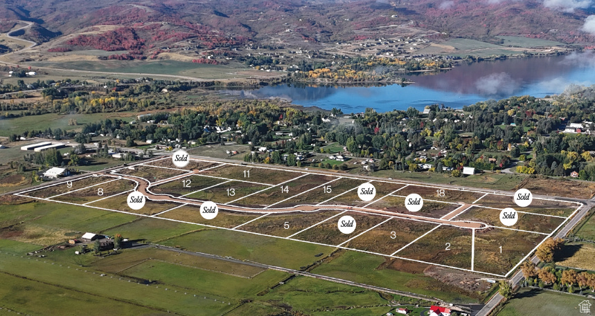 Aerial view of property's location featuring a large body of water