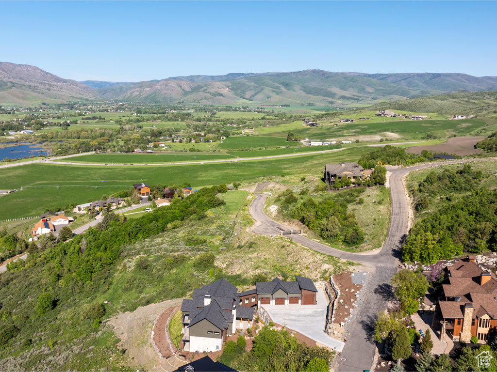Aerial view of property and surrounding area with a mountain backdrop and rural landscape