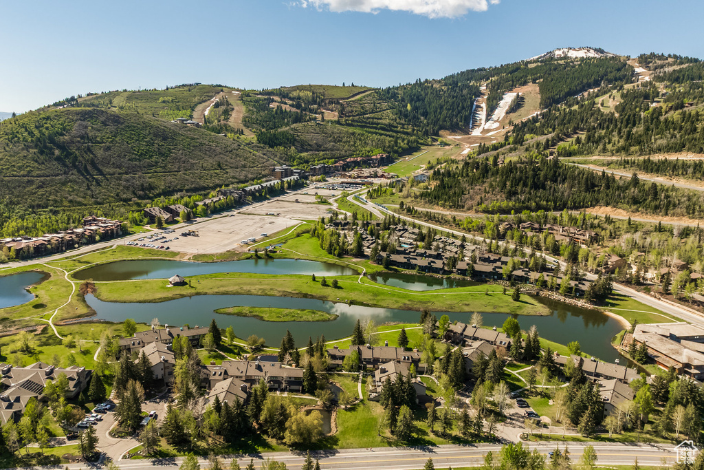 View of property location featuring a water and mountain view and nearby suburban area