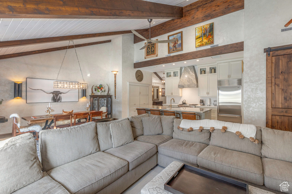 Living area featuring high vaulted ceiling, ceiling fan, and wood ceiling with exposed beams