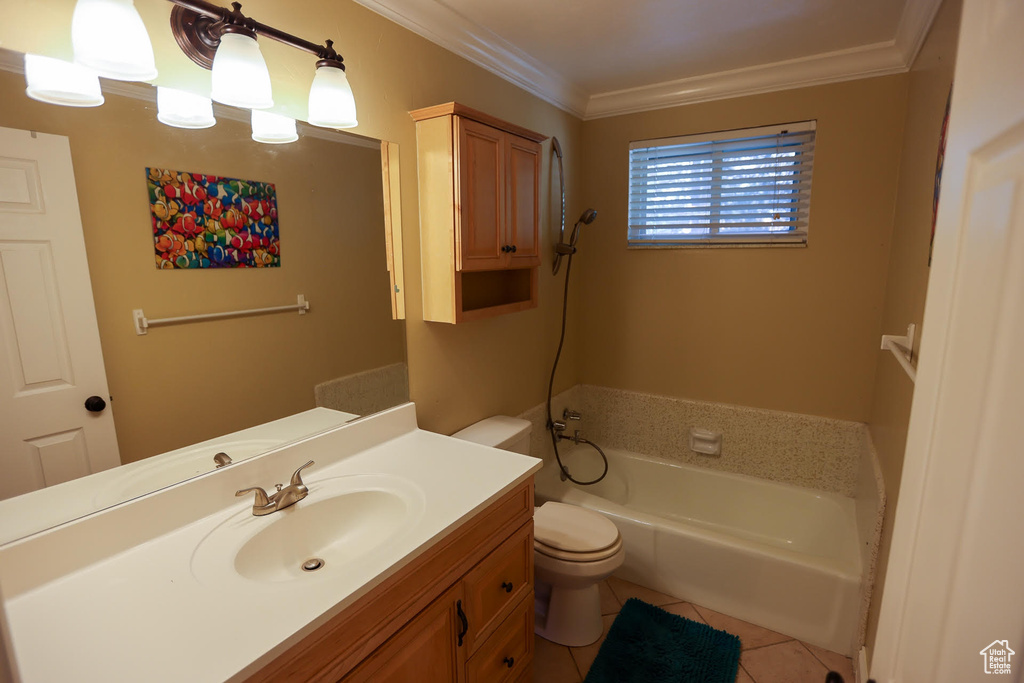 Bathroom with a tub to relax in, tile patterned flooring, vanity, toilet, and crown molding