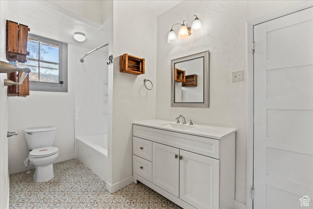 Full bathroom with shower / bathtub combination, vanity, toilet, and tile patterned floors