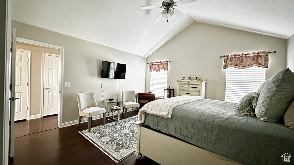 Bedroom featuring multiple windows, dark wood-type flooring, ceiling fan, and vaulted ceiling