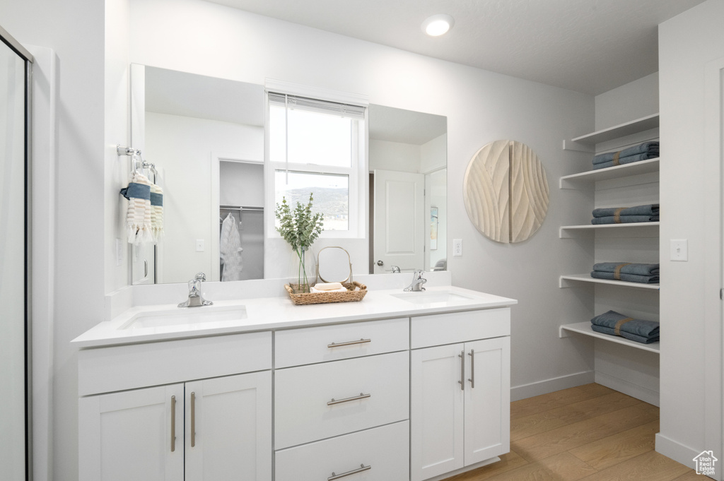 Bathroom featuring hardwood / wood-style flooring and vanity