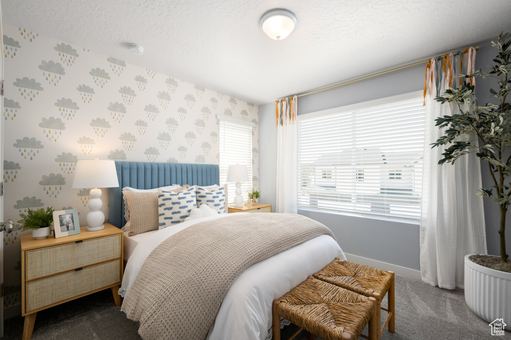 Carpeted bedroom featuring a textured ceiling