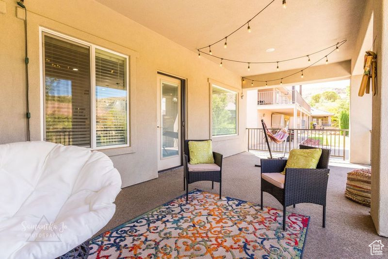 View of patio featuring a balcony