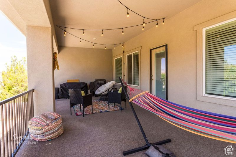 View of patio featuring a balcony
