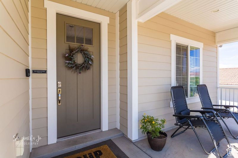 Doorway to property featuring a porch