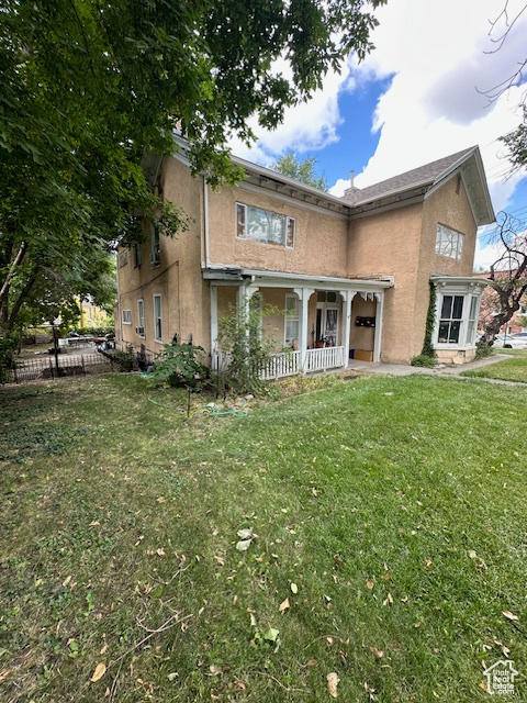 View of front of house with a front yard and covered porch