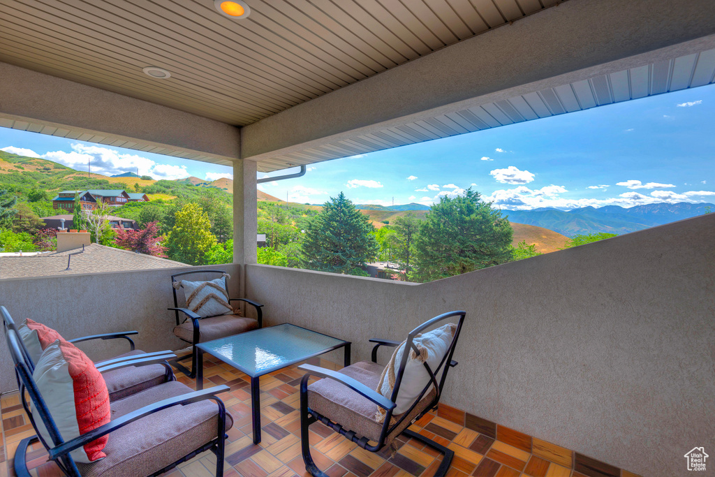 View of patio featuring a balcony and a mountain view