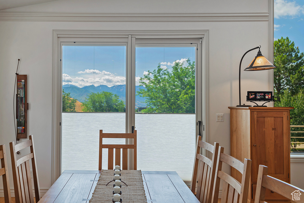 Dining area featuring a water and mountain view