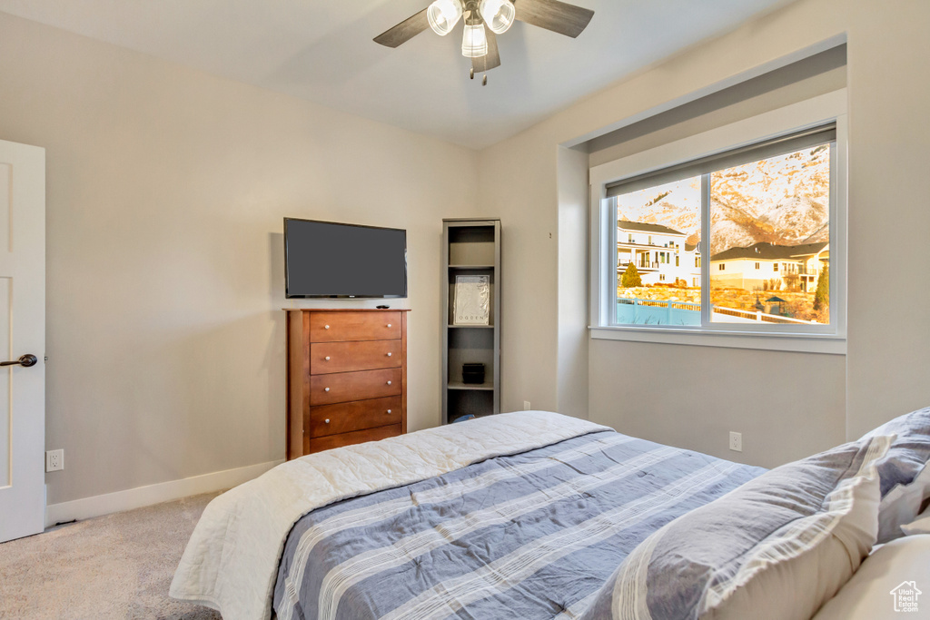 Bedroom with ceiling fan and carpet floors