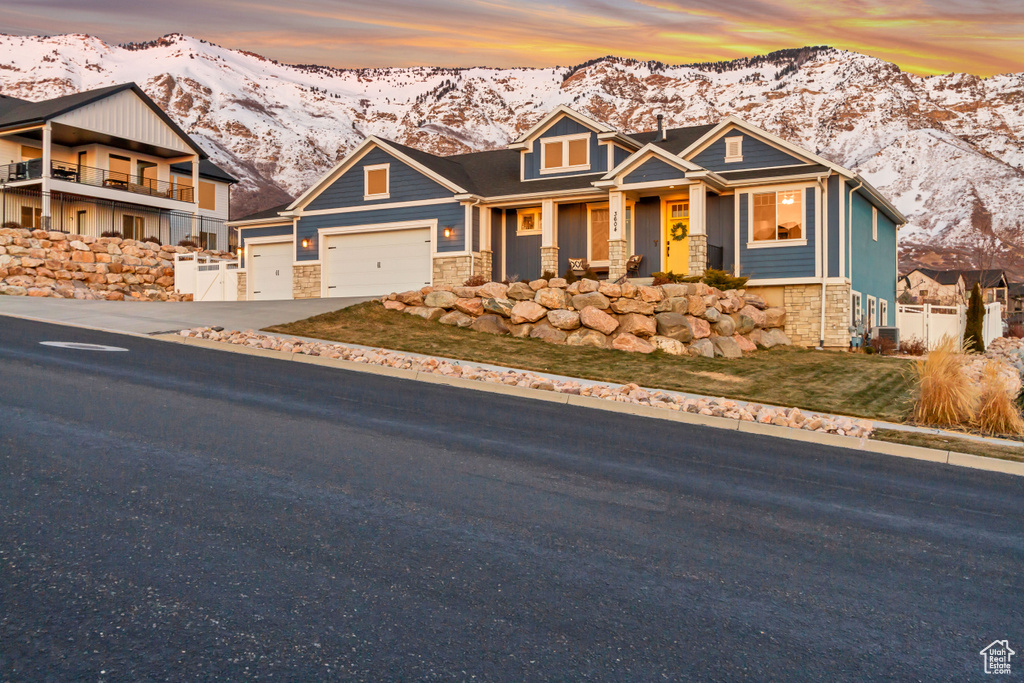 Craftsman inspired home featuring a mountain view and a garage