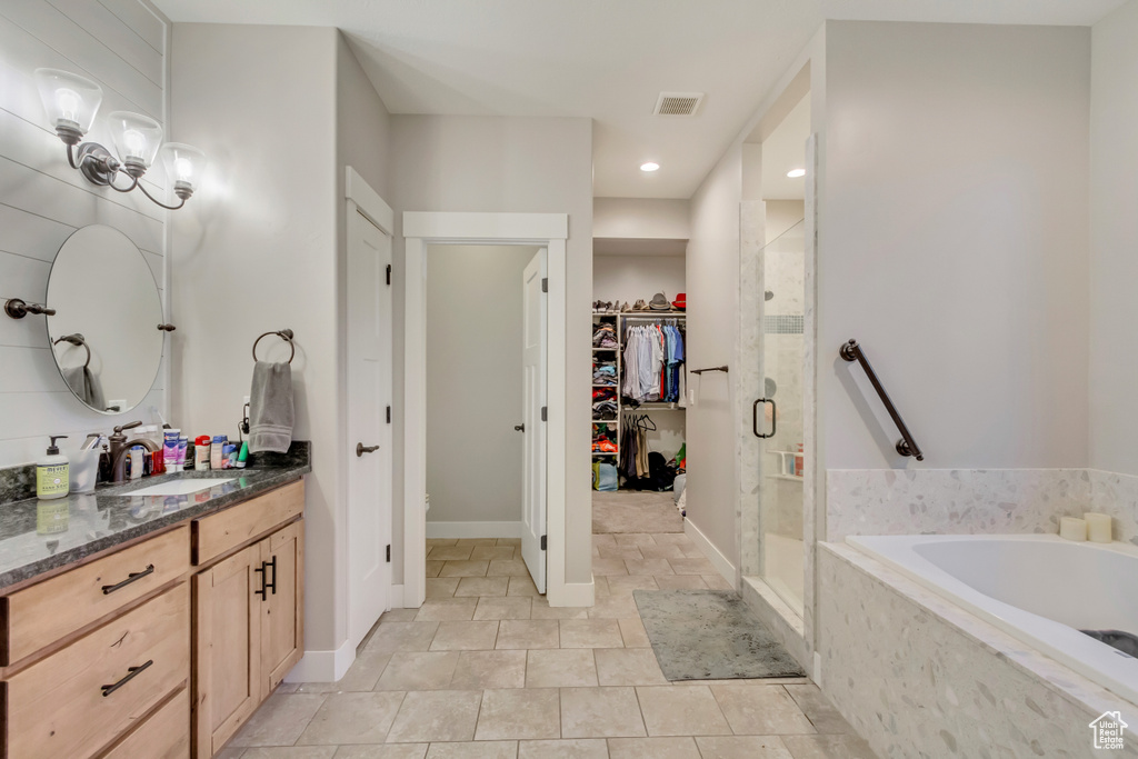 Bathroom with shower with separate bathtub and vanity