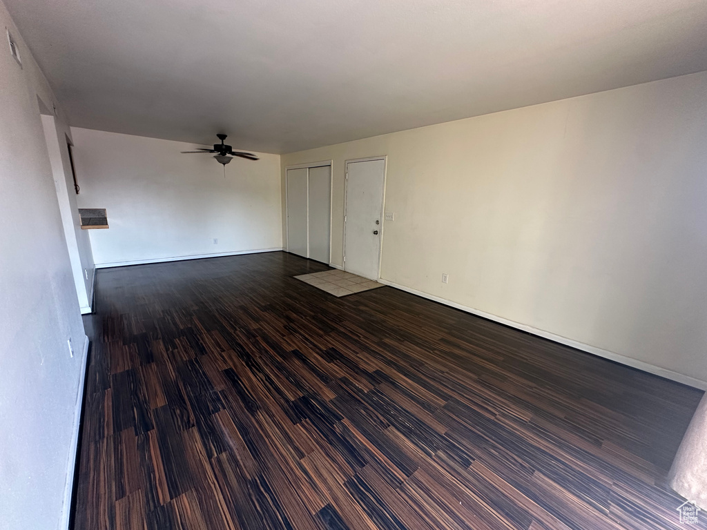 Spare room with ceiling fan and dark hardwood / wood-style flooring