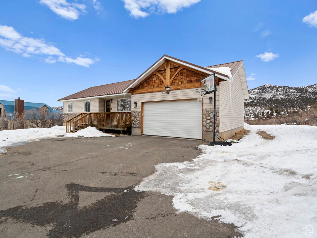 View of front facade with a garage and a mountain view