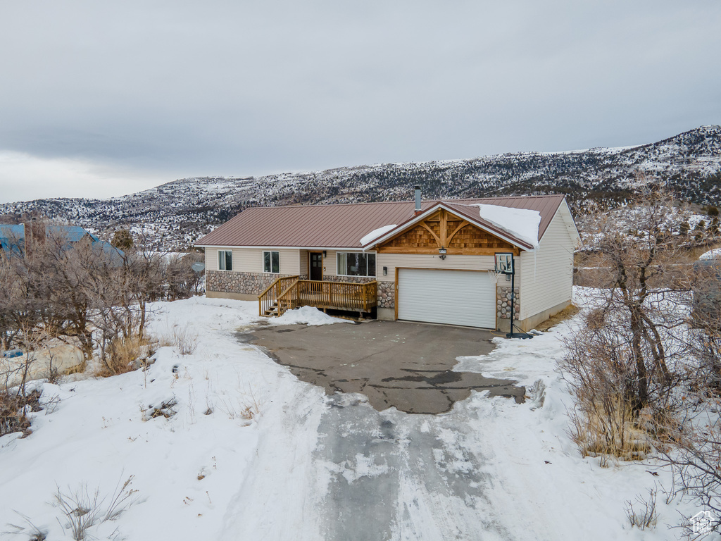 View of front facade with a garage and a mountain view