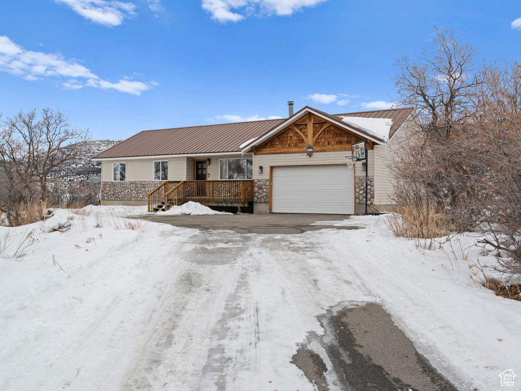 Single story home with a garage and a deck