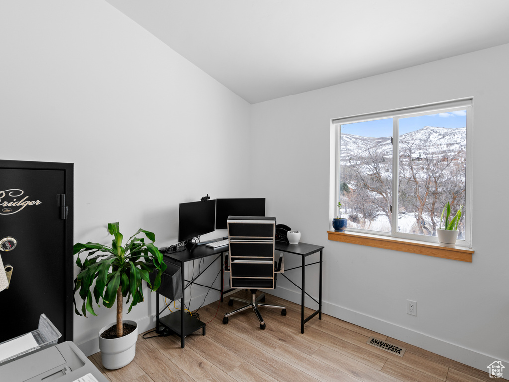 Office with light hardwood / wood-style flooring