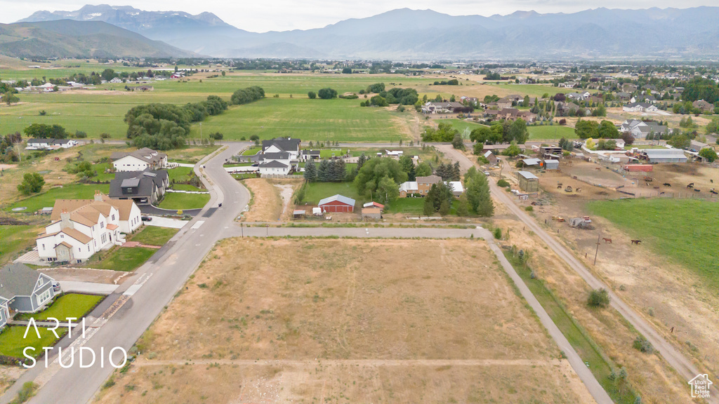 Aerial overview of property's location featuring a mountain backdrop and rural landscape