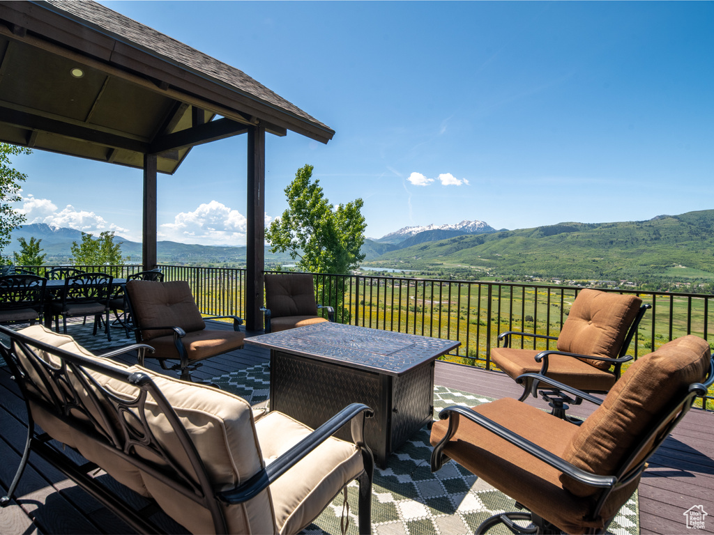 Wooden terrace with a mountain view and an outdoor living space