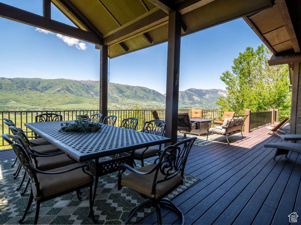 Wooden terrace with a mountain view and outdoor dining space