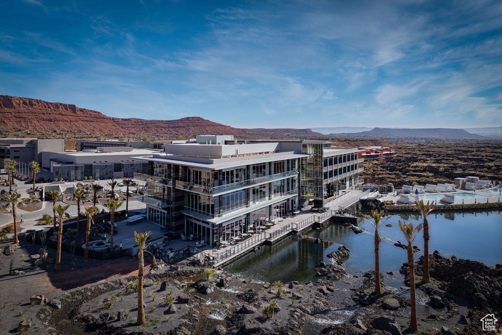 View of property with a water and mountain view