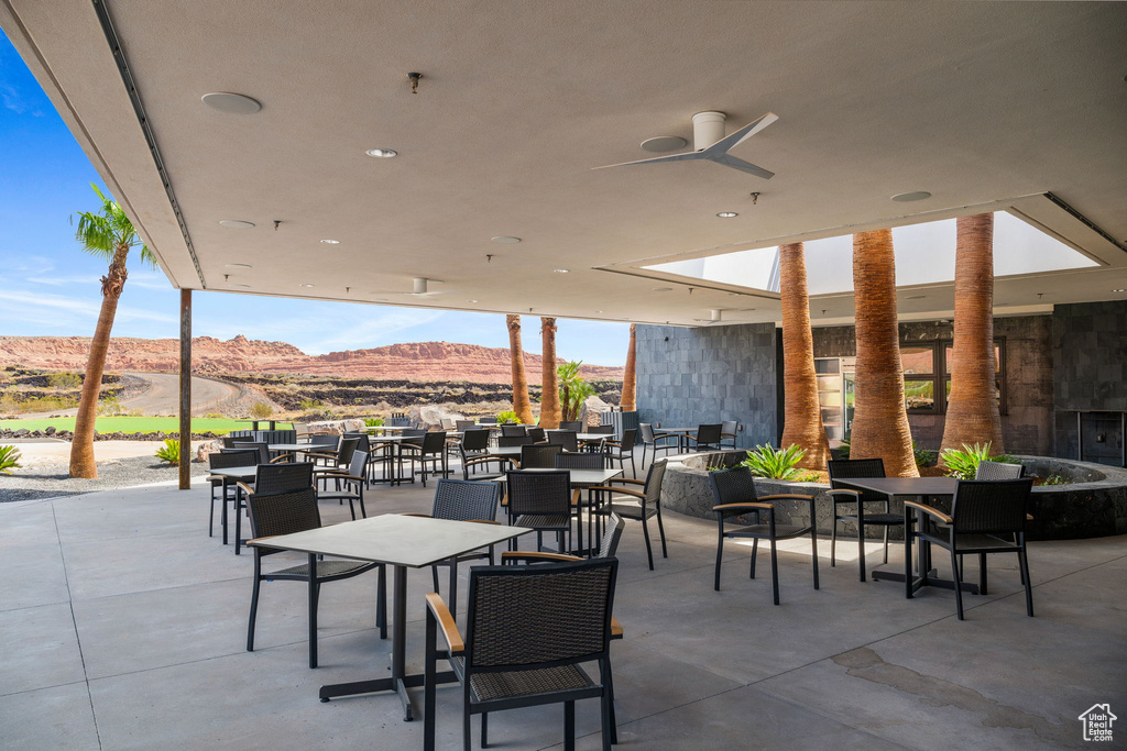 View of patio / terrace featuring a mountain view and ceiling fan