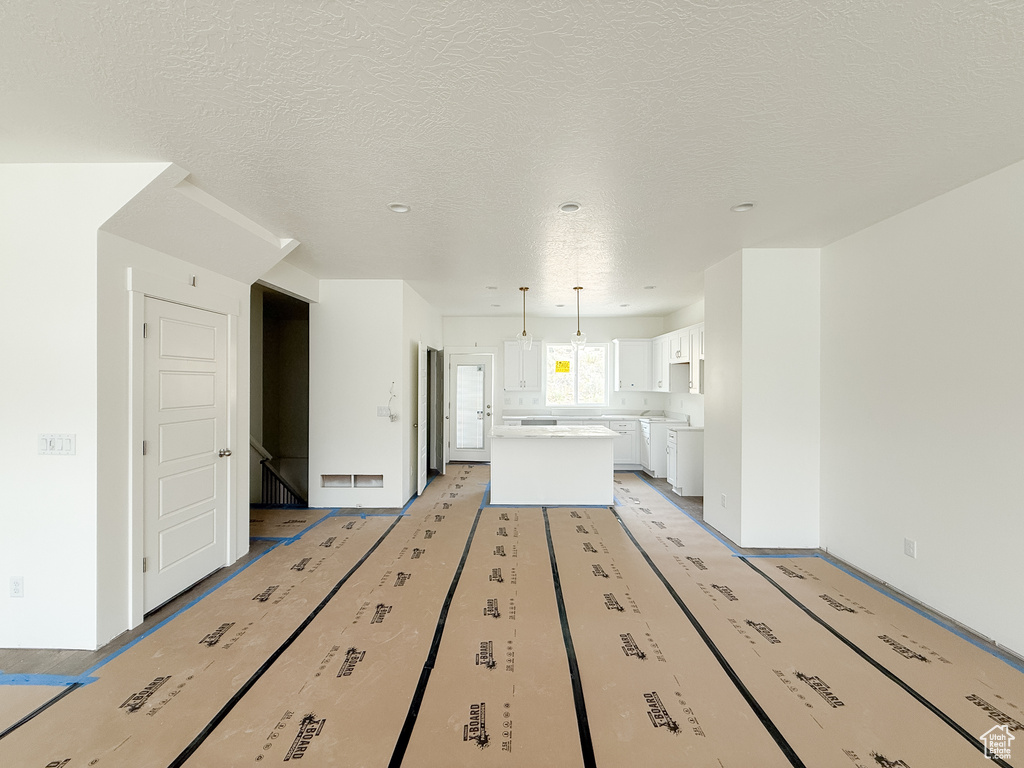 Unfurnished living room featuring a textured ceiling