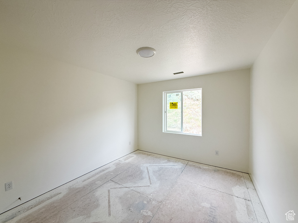 Empty room with a textured ceiling