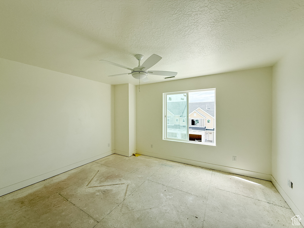 Empty room with baseboards and ceiling fan