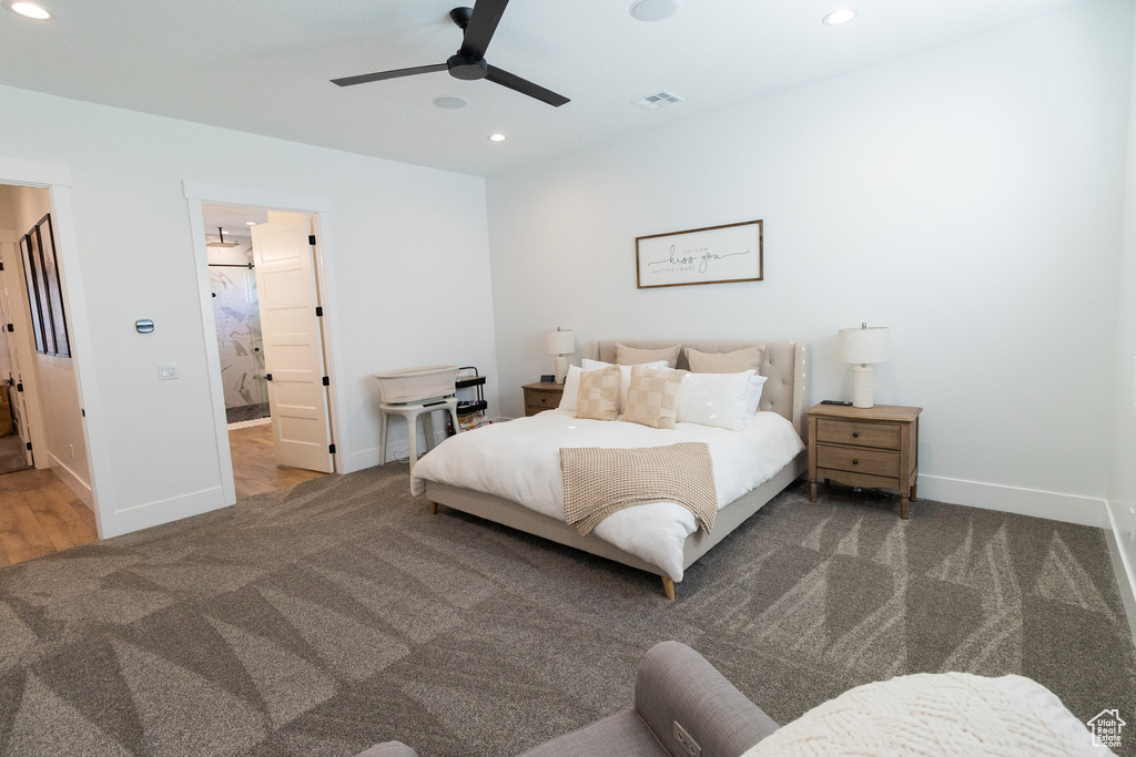 Carpeted bedroom featuring ceiling fan