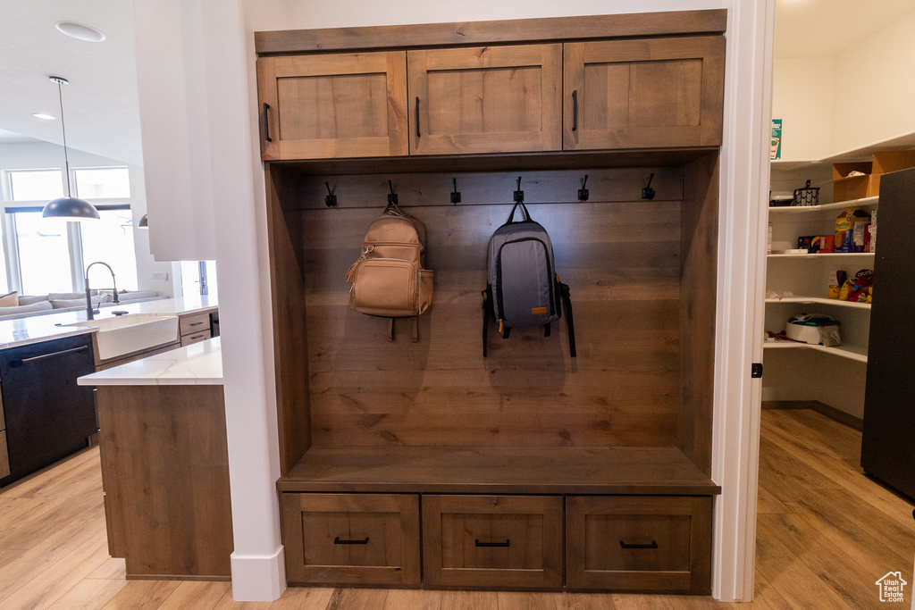 Mudroom featuring sink and light wood-type flooring